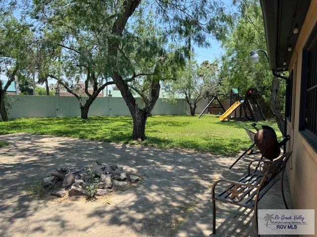 1875 Sancho Panza Cir, Brownsville, TX 78521 - view of patio featuring a playground