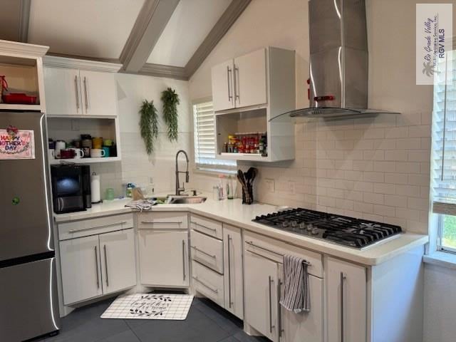 1875 Sancho Panza Cir, Brownsville, TX 78521 - kitchen featuring open shelves, stainless steel appliances, wall chimney range hood, a sink, and tasteful backsplash
