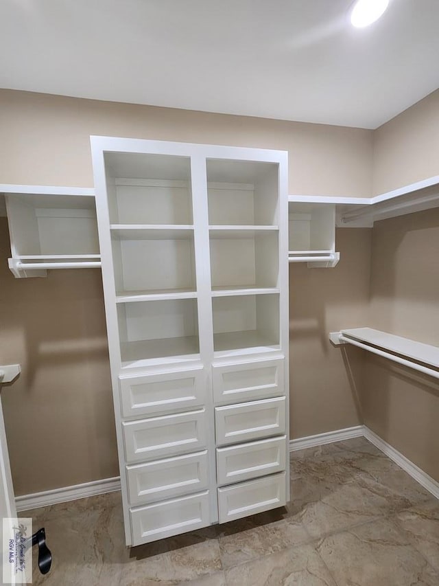 spacious closet with marble finish floor