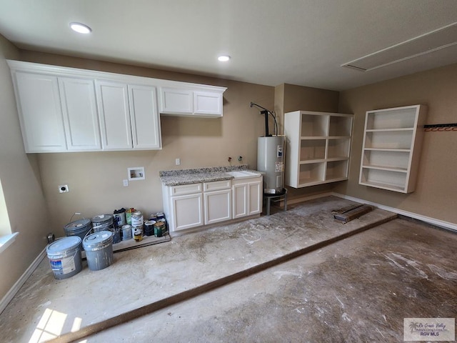 garage with baseboards and electric water heater