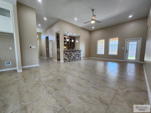 unfurnished living room with recessed lighting, baseboards, and ceiling fan