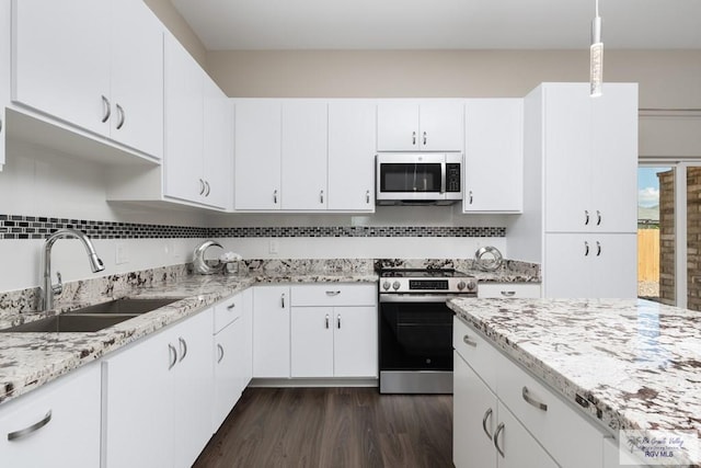 kitchen featuring sink, stainless steel appliances, dark hardwood / wood-style flooring, pendant lighting, and white cabinets