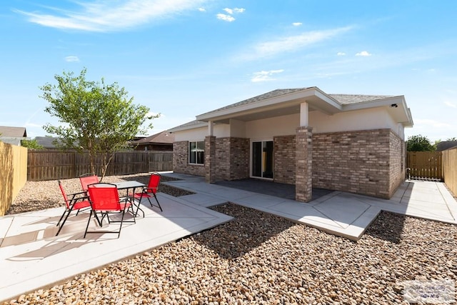 back of house with a patio