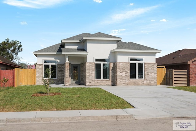 6121 Guadalupe River St, Brownsville, TX 78521 - prairie-style house featuring stucco siding and roof with shingles