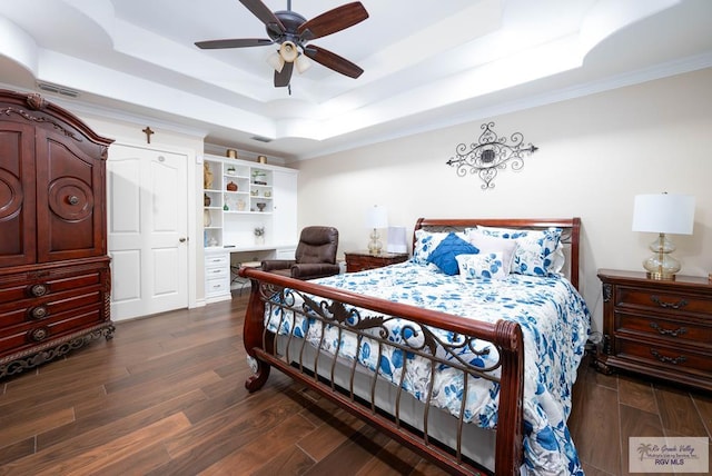 bedroom featuring ornamental molding, a raised ceiling, ceiling fan, and dark wood-type flooring