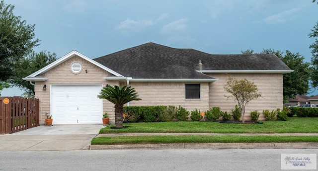 view of front of home with a front lawn and a garage