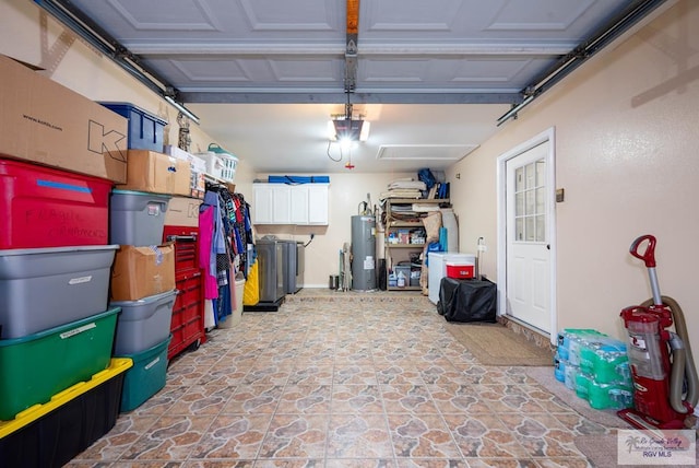 garage featuring electric water heater and a garage door opener