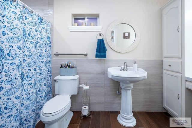 bathroom with hardwood / wood-style flooring, toilet, tile walls, and a shower with shower curtain