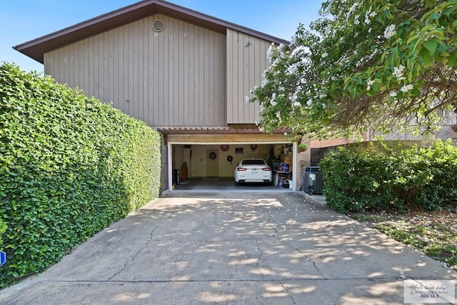105 E Austin Ave, Harlingen, TX 78550 - view of property exterior featuring concrete driveway and a garage