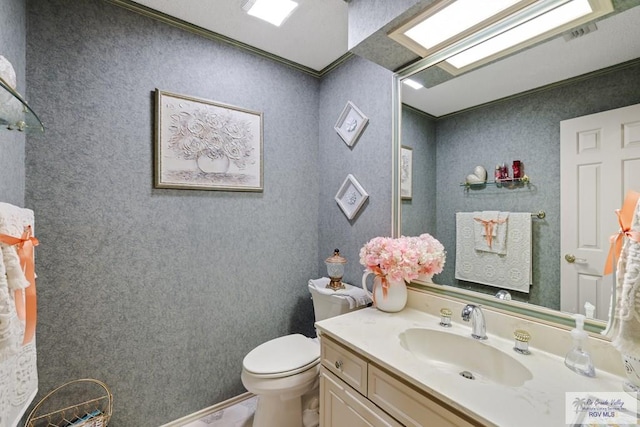 105 E Austin Ave, Harlingen, TX 78550 - bathroom with toilet, vanity, and crown molding