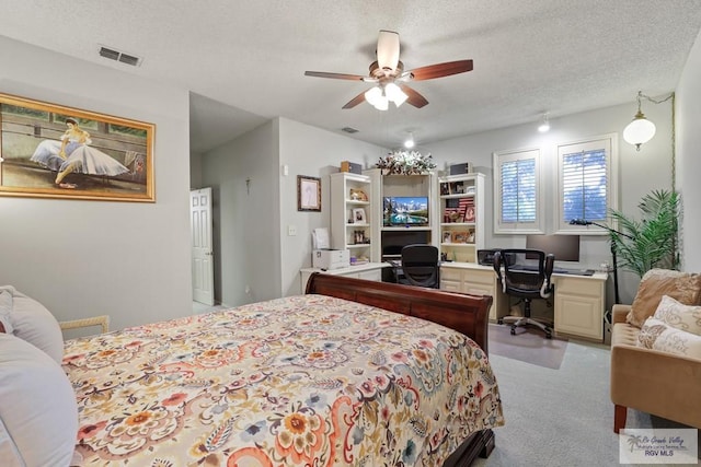 105 E Austin Ave, Harlingen, TX 78550 - carpeted bedroom featuring a textured ceiling and ceiling fan