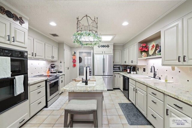 105 E Austin Ave, Harlingen, TX 78550 - kitchen featuring black appliances, a sink, ornamental molding, tasteful backsplash, and recessed lighting