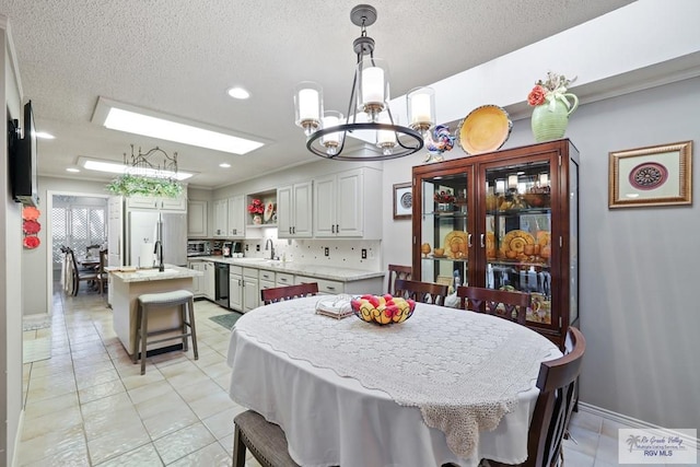 105 E Austin Ave, Harlingen, TX 78550 - dining area with a chandelier, a textured ceiling, light tile patterned floors, recessed lighting, and baseboards