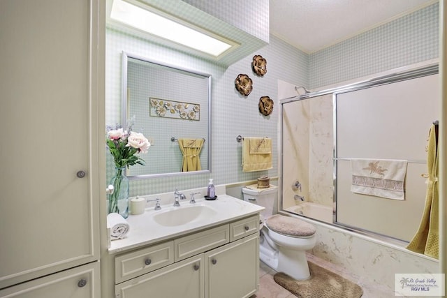 105 E Austin Ave, Harlingen, TX 78550 - bathroom featuring vanity, wallpapered walls, toilet, enclosed tub / shower combo, and tile patterned flooring