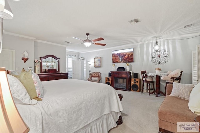 105 E Austin Ave, Harlingen, TX 78550 - carpeted bedroom with ornamental molding, ceiling fan, and a glass covered fireplace