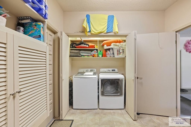 105 E Austin Ave, Harlingen, TX 78550 - laundry area with washer and clothes dryer, light tile patterned floors, and a textured ceiling
