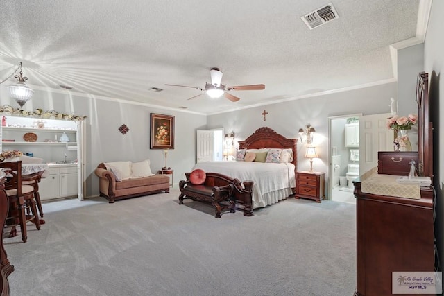 105 E Austin Ave, Harlingen, TX 78550 - bedroom featuring crown molding, light carpet, a textured ceiling, connected bathroom, and a ceiling fan