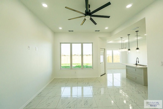 interior space featuring ceiling fan and sink