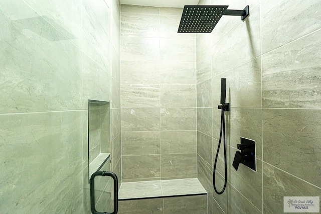 bathroom with a shower with door