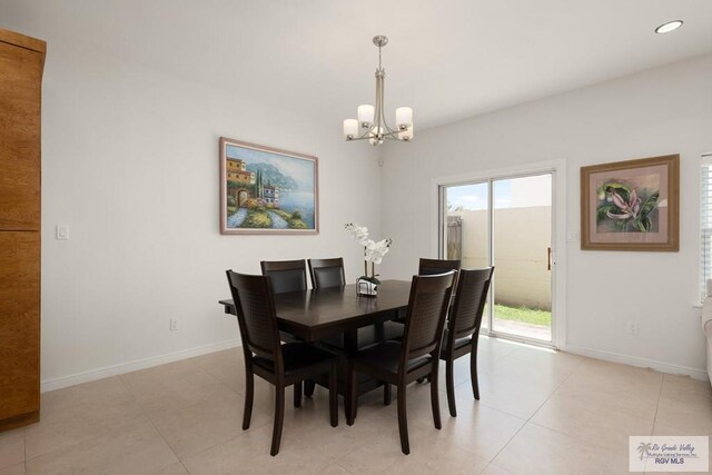 dining space featuring light tile patterned floors and a chandelier