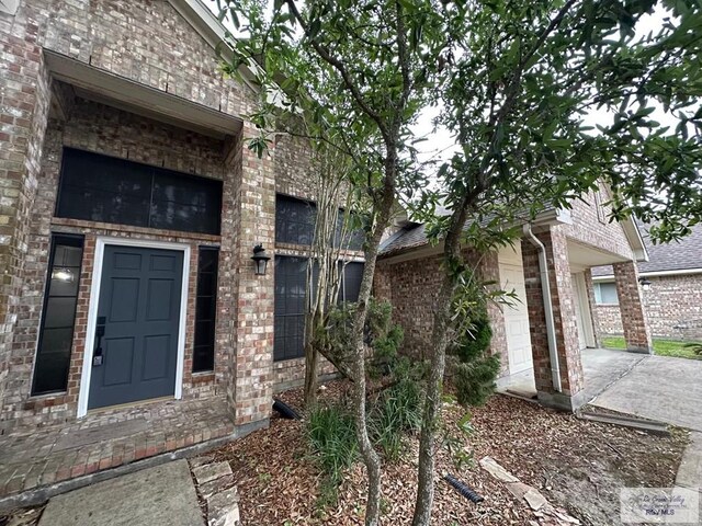 property entrance with brick siding