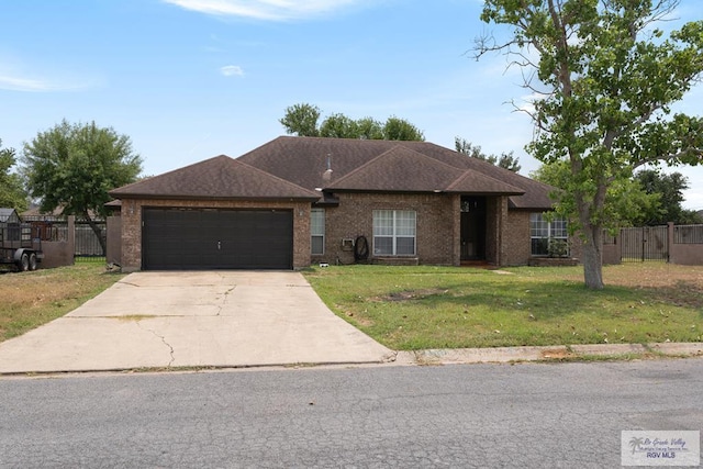 ranch-style home with a garage and a front yard