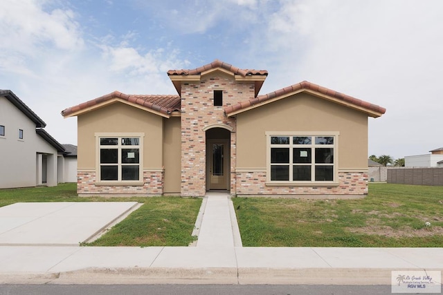 mediterranean / spanish house with a front lawn