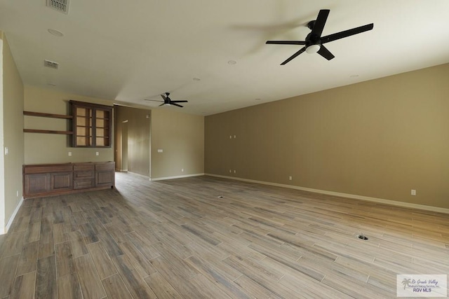 unfurnished living room with ceiling fan and hardwood / wood-style floors