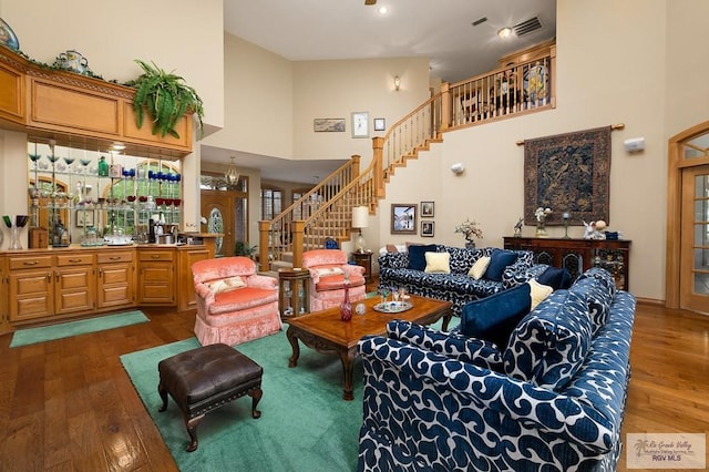 27603 Palo Verde Rd, San Benito, TX 78586 - living area with wood finished floors, stairway, a towering ceiling, and bar