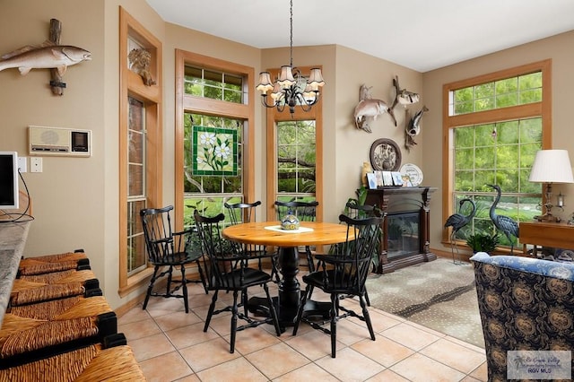 27603 Palo Verde Rd, San Benito, TX 78586 - dining area featuring a chandelier, light tile patterned flooring, and a glass covered fireplace