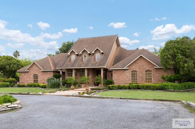 27603 Palo Verde Rd, San Benito, TX 78586 - view of front facade featuring brick siding, a front lawn, and a shingled roof