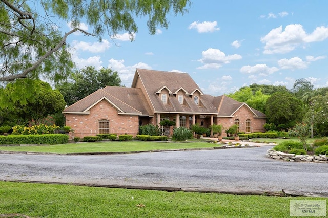 27603 Palo Verde Rd, San Benito, TX 78586 - cape cod house with brick siding and a front lawn