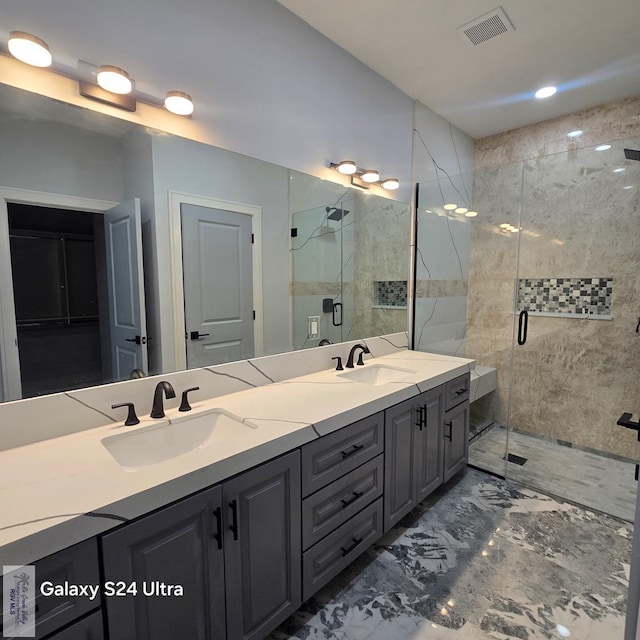 bathroom with marble finish floor, a sink, double vanity, and visible vents