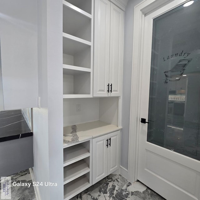 mudroom featuring baseboards and marble finish floor