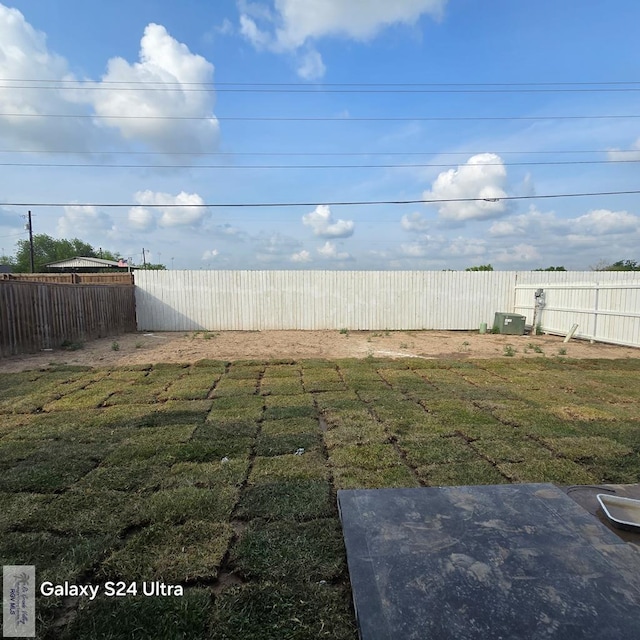 view of yard with a fenced backyard