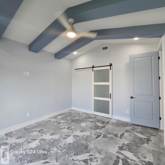 empty room featuring a barn door, visible vents, baseboards, vaulted ceiling with beams, and marble finish floor