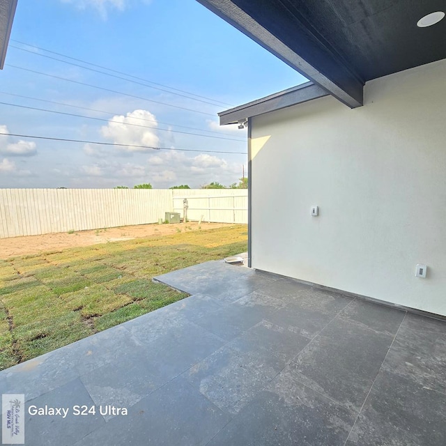 view of patio featuring fence
