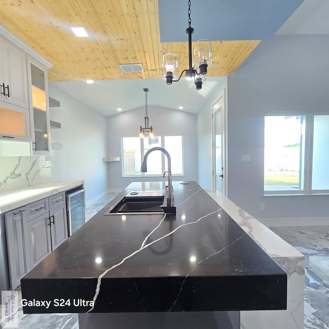 kitchen with beverage cooler, wooden ceiling, an inviting chandelier, a sink, and baseboards