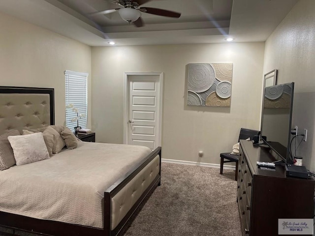 bedroom with ceiling fan, recessed lighting, baseboards, a tray ceiling, and dark carpet