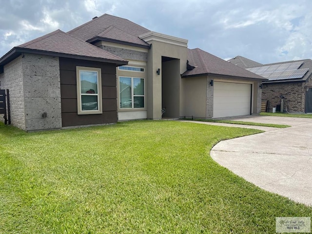 view of front facade featuring a shingled roof, an attached garage, driveway, and a front lawn