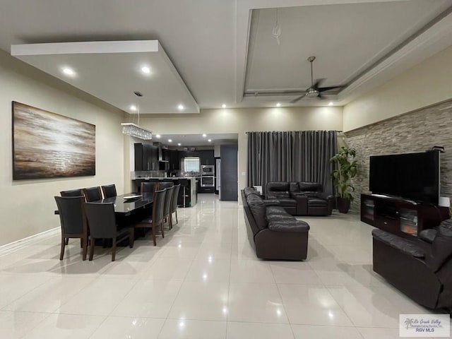 living area with light tile patterned flooring, a ceiling fan, and recessed lighting