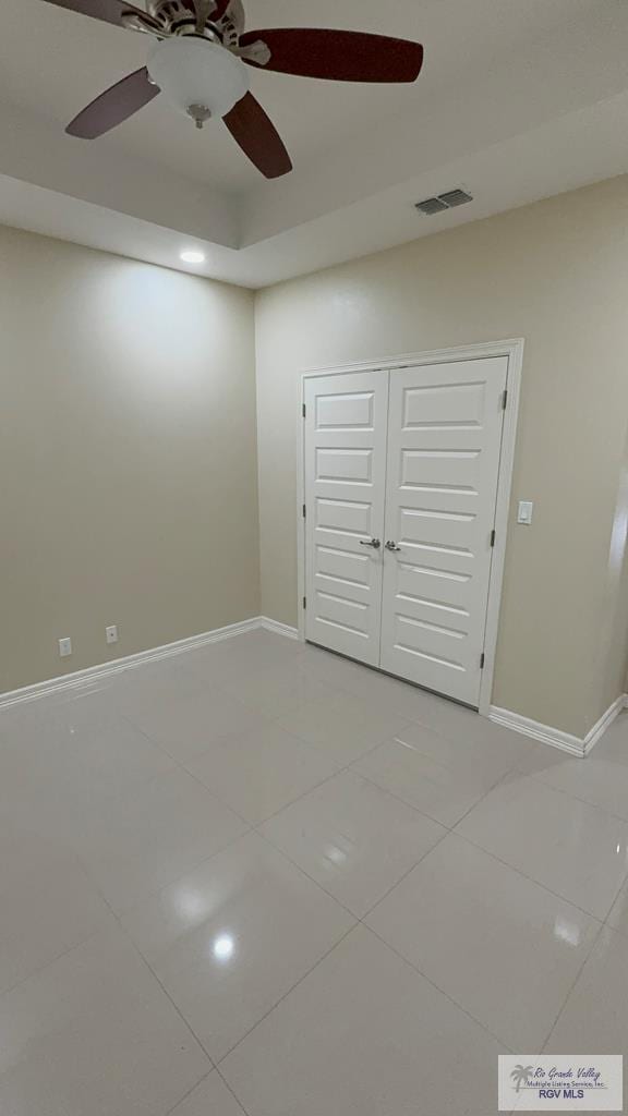 interior space featuring baseboards, visible vents, and tile patterned floors