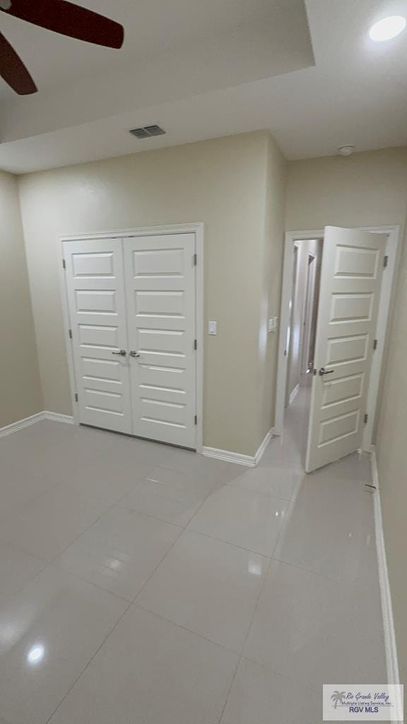 interior space featuring baseboards, visible vents, a closet, and tile patterned floors