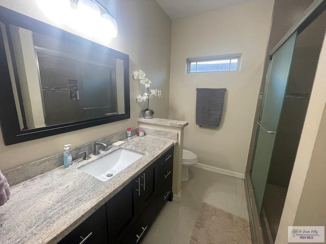 full bath featuring toilet, a shower stall, vanity, tile patterned flooring, and baseboards