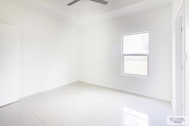 unfurnished room with ceiling fan and light tile patterned floors