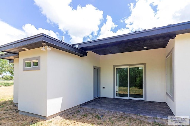 rear view of property featuring a patio area