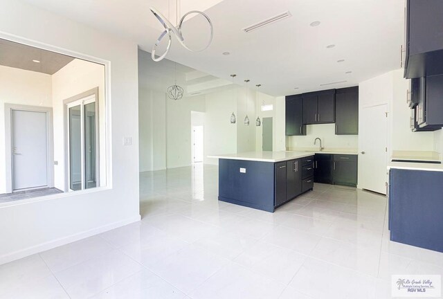 kitchen featuring light tile patterned floors, sink, hanging light fixtures, and an inviting chandelier