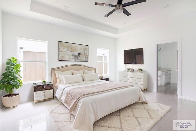 tiled bedroom with connected bathroom and ceiling fan