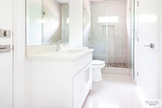 bathroom with tile patterned flooring, vanity, an enclosed shower, and toilet