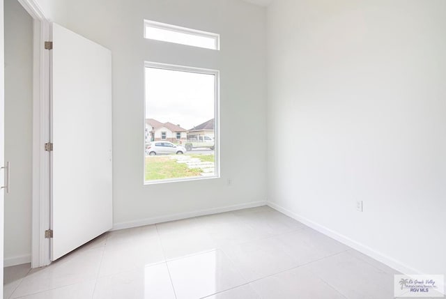 spare room with light tile patterned floors